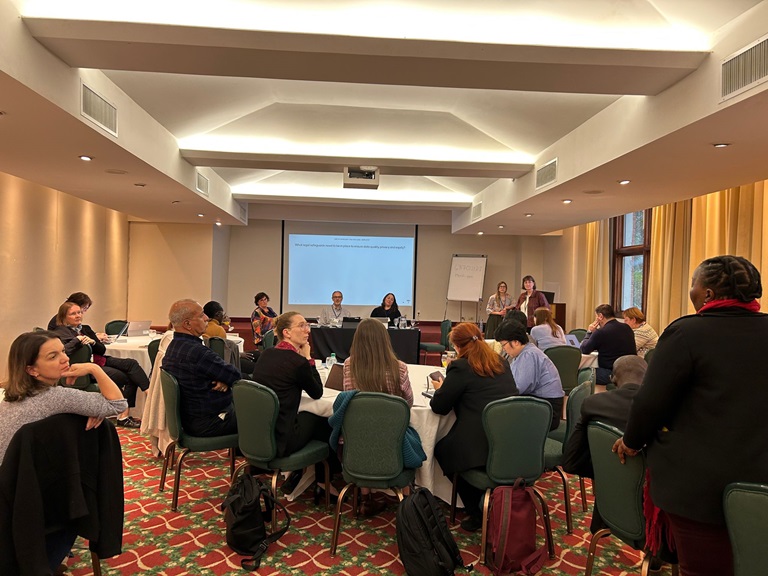 Round tables with people discussing in a meeting.